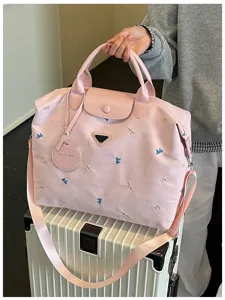 Pink travel duffel bag with cute bow embroidery, top handles and shoulder strap for fitness.