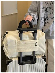 Large capacity travel duffel bag with luggage sleeve and durable handle for short trips.