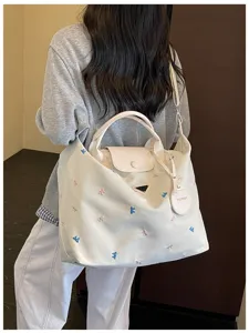 Large capacity canvas travel tote bag with cute bow embroidery, ideal for casual commute and trips.