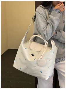 Korean style large canvas travel tote bag with embroidery, top handle and shoulder strap.
