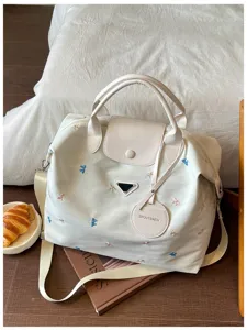 Large capacity casual travel duffel bag with cute bow embroidery and top handle design.