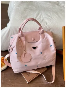 Pink travel duffel bag with cute bow embroidery, large capacity shoulder bag for women.