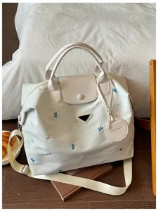 Large capacity travel duffel bag for women, stylish embroidered bow tote gym bag for commuting.