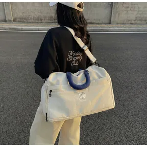 Large capacity travel duffel bag with shoulder strap, perfect for fitness and weekend trips outdoors.
