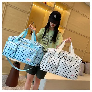 Detailed view of large capacity polka dot travel duffel bag with multi-pockets and stylish design.