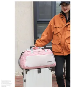 Pink travel duffel bag detail, large capacity gym bag with handle and shoulder strap for fitness.