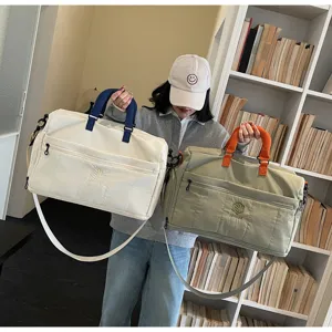 Large capacity travel duffel bag with contrasting handles, casual canvas gym and luggage bag for women.