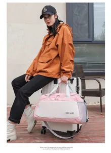Pink and white travel gym bag detail showing dual handles, durable fabric, and spacious compartments.