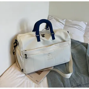 Large capacity travel duffel bag with contrast blue handle for casual and fitness use.