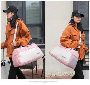 Detailed view of the pink and white travel duffel bag with shoulder strap and wet compartment.