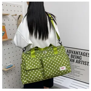 Green polka dot travel duffel bag detail showing large capacity and side pockets.