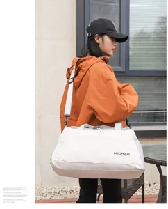 Details view of the large capacity travel duffel bag with shoulder strap and stylish design.