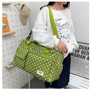 Green polka dot travel duffel bag with large capacity, multi-pocket design, stylish and functional.