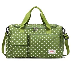 Green polka dot travel duffel bag with large capacity, waterproof design for sports and gym fitness.