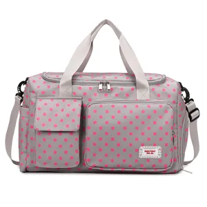 Grey polka dot travel duffel bag with large capacity, shoulder strap, and front pocket.