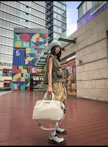 Details of the beige large-capacity travel duffel bag showing durable fabric and straps.
