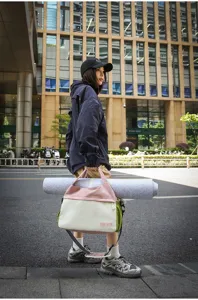 Detail view of the colorful color-block travel bag, large capacity, perfect for gym and trips.