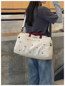 Large capacity travel duffel bag with dry wet separation, stylish shoulder gym bag for women.