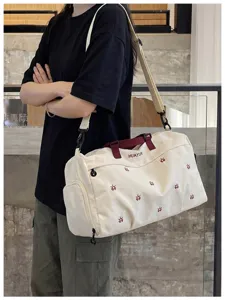 Detailed shot of large capacity canvas travel duffel bag with dry wet separation feature.
