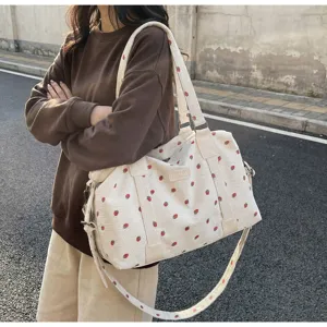 Large capacity travel duffel bag with cute strawberry print corduroy shoulder bag daily use.