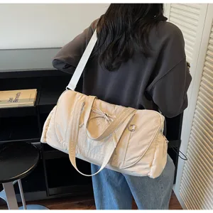 Large capacity travel duffel shoulder bag detail view, waterproof fitness luggage bag in beige.