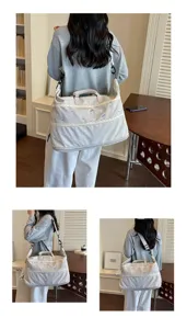 Spacious light gray travel duffel bag with delicate lace trim and cute embroidery for women.