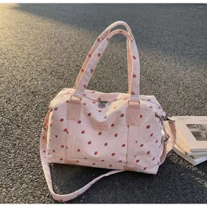 Pink corduroy travel duffel bag with cute strawberry print, large capacity and crossbody strap.