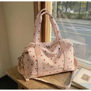 Pink corduroy travel duffel bag with cute strawberry print, large capacity for short trips.