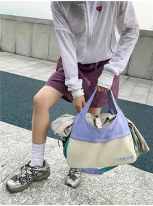 Close-up of color-blocked travel tote bag, casual daily shoulder bag, large capacity.