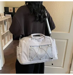 Detail view of large capacity expandable travel gym bag with dry wet separation pocket.