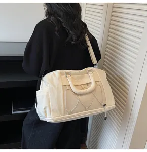 Large capacity travel duffel gym bag detail, stylish beige expandable weekend luggage.
