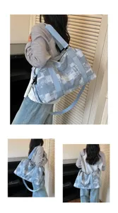 Detailed view of large capacity travel duffel bag in light blue abstract pattern with straps.