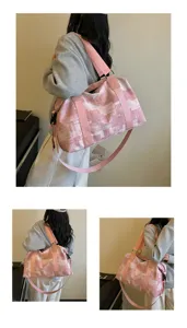 Detailed view of the pink plaid travel gym bag, showing texture and adjustable strap.