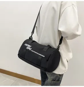 Cylindrical sports duffel bag detail, black design with white print for daily gym and travel.