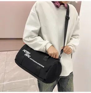 Black cylindrical sports fitness duffel bag for travel gym and outdoor portable luggage use.