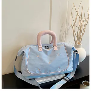 Blue travel duffel bag with pink handles and cute bow embroidery, large capacity gym bag.