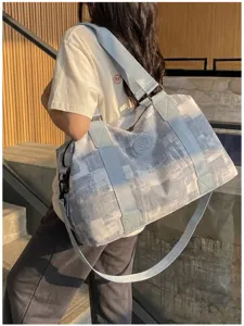 Large capacity travel duffel bag with stylish abstract pattern, comfortable wide shoulder strap.