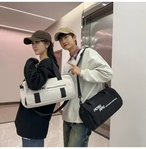Close-up details of the large capacity cylindrical gym duffel bag in indoor scene.
