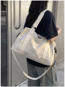Large capacity travel duffel bag with PU texture, stylish gym sports shoulder bag for daily use.