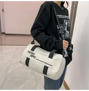 Cylindrical sports duffel bag with black straps, stylish travel gym luggage bag for daily use.