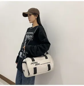 Large capacity sports duffel bag for gym, travel and fitness, white cylindrical design with black straps.