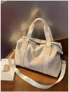 Detailed view of large capacity retro travel duffel bag with PU texture and sturdy straps.