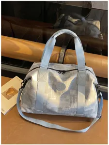 Large capacity travel duffel bag with stylish textured surface and shoulder strap.