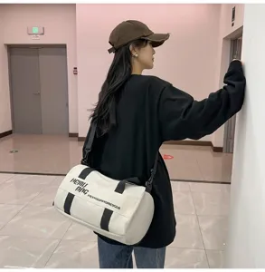 Duffel bag for sports and travel with large capacity and cylindrical design in white.