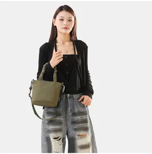 Élégant sac seau en toile vert armée avec poignée froncée et bandoulière pour femmes.