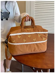 Brown travel duffle bag with white lace trim and yellow embroidered bows for gym and trips