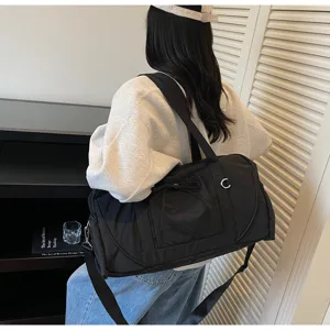 Large capacity black nylon duffel bag for travel, fitness, and daily commuting needs.