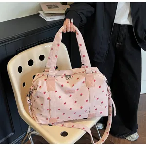 Detailed view of large capacity pink corduroy travel duffel bag with cute strawberry print.