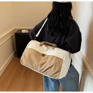Detailansicht der zweifarbigen Reisetasche mit Leinwandmaterial und bequemem Schulterriemen.