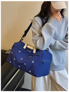 Blue travel duffel bag with large capacity, wet dry separation and shoulder strap design.